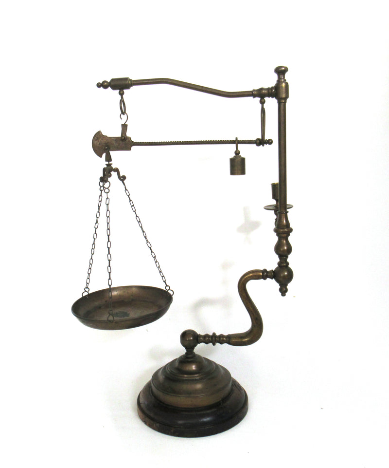 Vintage brass scale with weight, pan, and candle holder isolated